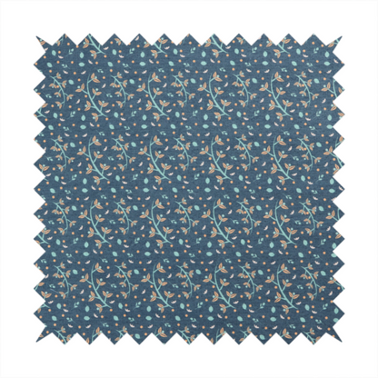 Slate blue textured fabric with a delicate ditsy botanical print. The repeating pattern features thin, curved mint green vine stems with small peach-coloured leaves, surrounded by tiny scattered peach polka dots and miniature teal leaf accents throughout the design.