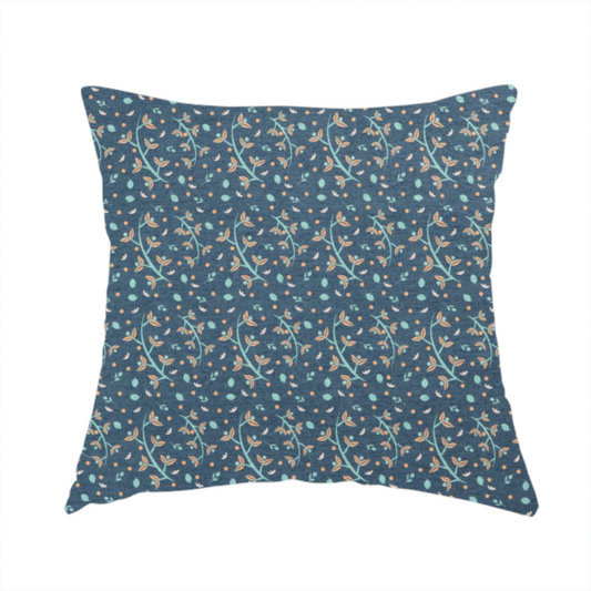 The fabric used to create this handmade cushion is a slate blue textured fabric with a delicate ditsy botanical print. The repeating pattern features thin, curved mint green vine stems with small peach-coloured leaves, surrounded by tiny scattered peach polka dots and miniature teal leaf accents throughout the design.
