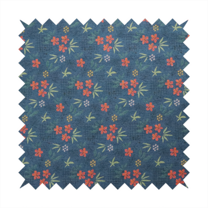 Deep teal blue fabric featuring a subtle crosshatch texture and a tropical botanical print. The repeating pattern showcases clusters of small rust-coral flowers, sage green palm fronds, and scattered miniature yellow starburst blooms.