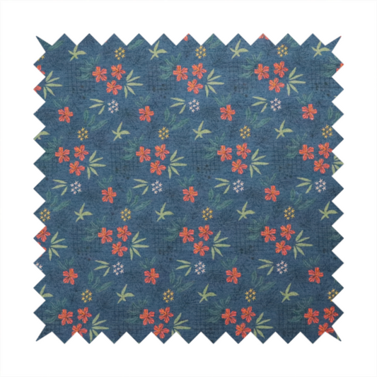 Deep teal blue fabric featuring a subtle crosshatch texture and a tropical botanical print. The repeating pattern showcases clusters of small rust-coral flowers, sage green palm fronds, and scattered miniature yellow starburst blooms.