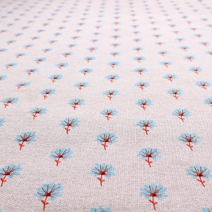 Light pink textured canvas fabric featuring a dainty, minimalist ditsy floral print. The pattern consists of neat, repeating rows of tiny cornflower blue wildflowers with slender reddish-brown stems spread evenly across the soft pastel background.