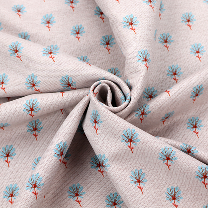 Light pink textured canvas fabric featuring a dainty, minimalist ditsy floral print. The pattern consists of neat, repeating rows of tiny cornflower blue wildflowers with slender reddish-brown stems spread evenly across the soft pastel background.