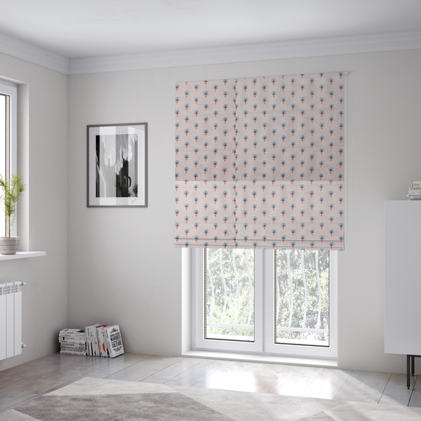 The fabric used to create these Roman blinds is a light pink textured canvas fabric featuring a dainty, minimalist ditsy floral print. The pattern consists of neat, repeating rows of tiny cornflower blue wildflowers with slender reddish-brown stems spread evenly across the soft pastel background.