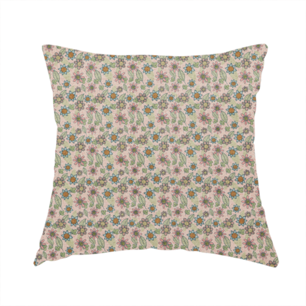 The fabric used to create this handmade cushion is a textured dusty blush pink fabric with a dense retro calico print. The intricate pattern features small, sketch-style daisies with mustard yellow centres and blue-teal petals, mixed with pink blooms and delicate sage green leaves spread tightly across the surface.