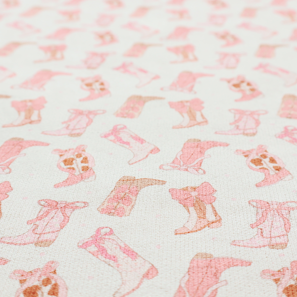 A repeating seamless pattern featuring an assortment of illustrated cowboy and cowgirl boots against a clean, off-white background. The boots are rendered in a soft, whimsical style with a colour palette consisting of various shades of pink, cream, light tan, and occasional brown accents.