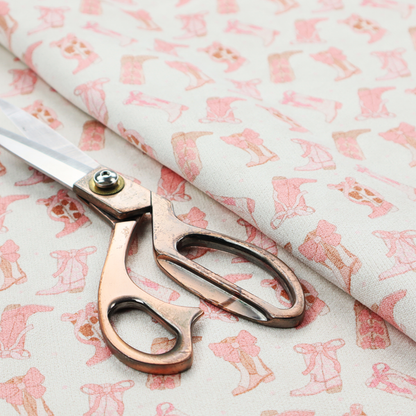 A repeating seamless pattern featuring an assortment of illustrated cowboy and cowgirl boots against a clean, off-white background. The boots are rendered in a soft, whimsical style with a colour palette consisting of various shades of pink, cream, light tan, and occasional brown accents.