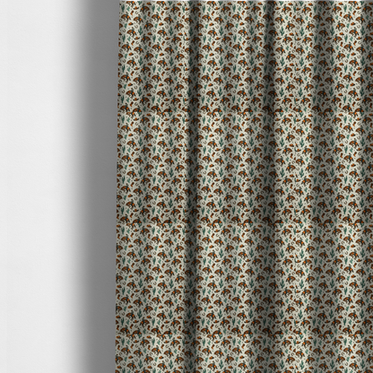 The fabric used to create these made-to-measure curtains is a seamless, repeating pattern featuring traditional western motifs in a classic comic or illustration style, set against a textured, light oatmeal or linen-look background. The colour palette relies heavily on bold terracotta orange, deep teal green, and dark brown accents.