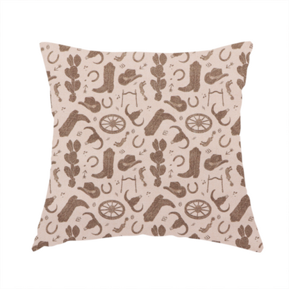 The fabric used to create this handmade cushion is a repeating toile-style western pattern featuring classic cowboy motifs printed in a monochromatic, textured medium-brown hue against a light beige background.
