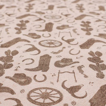 A repeating toile-style western pattern featuring classic cowboy motifs printed in a monochromatic, textured medium-brown hue against a light beige background.