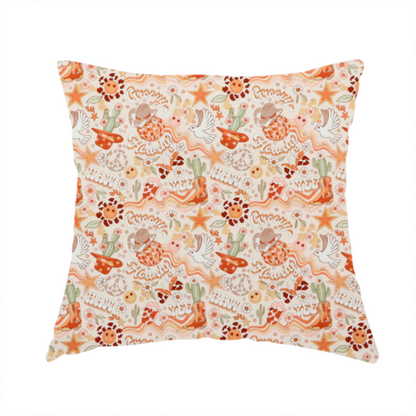 the fabric used to create this handmade cushion is a vibrant, repeating pattern blending 1970s retro elements with a western aesthetic, set against a light cream-colored background. The design uses a warm colour palette of terracotta orange, muted mustard yellow, sage green, and soft tan.