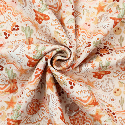 A vibrant, repeating pattern blending 1970s retro elements with a western aesthetic, set against a light cream-colored background. The design uses a warm colour palette of terracotta orange, muted mustard yellow, sage green, and soft tan.