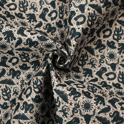 A dense, repeating pattern featuring black graphic silhouettes of classic southwestern and western elements printed on a heavily textured, woven beige fabric base.