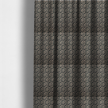 The fabric used to create these made-to-measure curtains is a dense, repeating pattern featuring black graphic silhouettes of classic southwestern and western elements printed on a heavily textured, woven beige fabric base.