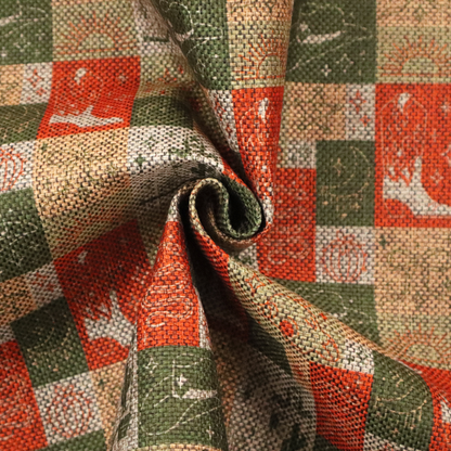 A repeating geometric patchwork pattern featuring western motifs framed inside distinct rectangular and square tiles. The design is printed on a heavily woven, textured linen-look fabric base. The Earth-toned colour palette consists of rich terracotta orange, olive green, muted sage, and warm cream.