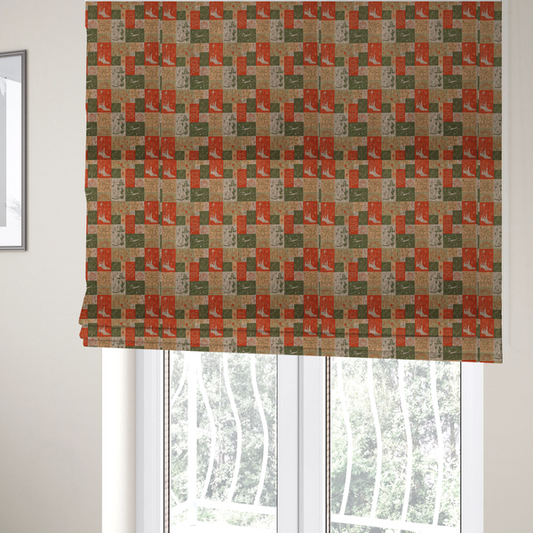 The fabric used to create these Roman blinds is a repeating geometric patchwork pattern featuring western motifs framed inside distinct rectangular and square tiles. The design is printed on a heavily woven, textured linen-look fabric base. The Earth-toned colour palette consists of rich terracotta orange, olive green, muted sage, and warm cream.