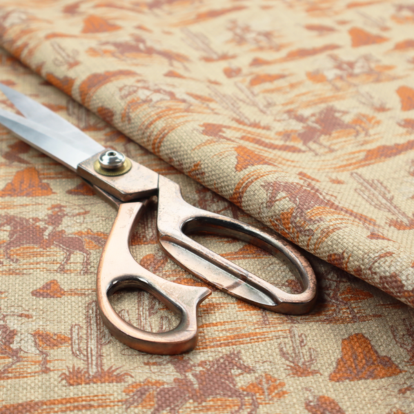 A repeating, scenic western toile pattern featuring detailed sketch-style illustrations over a heavily textured, linen-look light beige background. The monochrome design is rendered in warm tones of terracotta orange, rust, and dusty brown.
