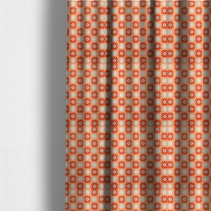 The fabric used to create these made-to-measure curtains is a uniform, repeating geometric pattern featuring southwestern and tribal-inspired motifs printed on a linen-textured background. The colour palette relies on warm, sun-baked tones, including a soft peach backdrop, vibrant terracotta orange, rust brown, and cream accents.