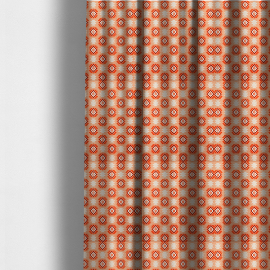The fabric used to create these made-to-measure curtains is a uniform, repeating geometric pattern featuring southwestern and tribal-inspired motifs printed on a linen-textured background. The colour palette relies on warm, sun-baked tones, including a soft peach backdrop, vibrant terracotta orange, rust brown, and cream accents.