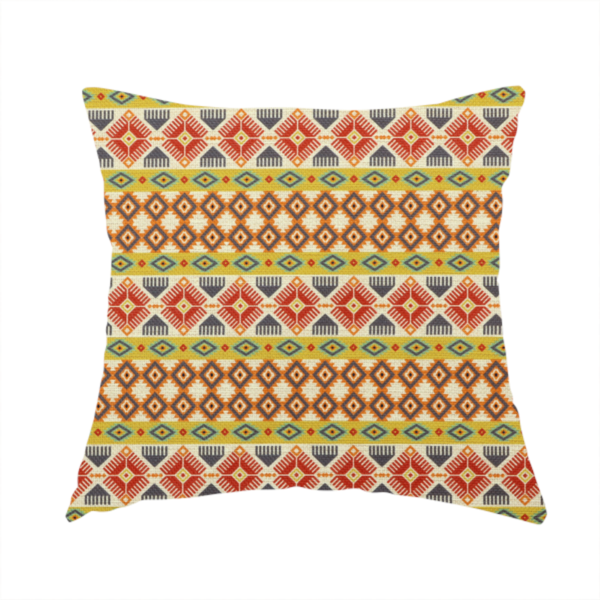The fabric used to create this handmade cushion is a vibrant, multi-coloured southwestern stripe pattern featuring repeating horizontal bands of geometric, tribal-inspired motifs. The detailed design is printed on a textured, linen-look cream fabric background, utilizing a bold colour palette of mustard yellow, terracotta red, slate blue-grey, and rust orange.
