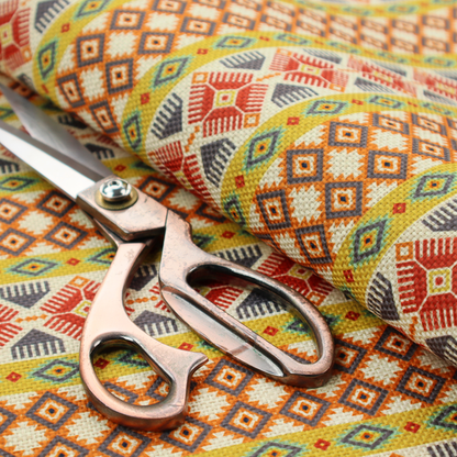 A vibrant, multi-coloured southwestern stripe pattern featuring repeating horizontal bands of geometric, tribal-inspired motifs. The detailed design is printed on a textured, linen-look cream fabric background, utilizing a bold colour palette of mustard yellow, terracotta red, slate blue-grey, and rust orange.
