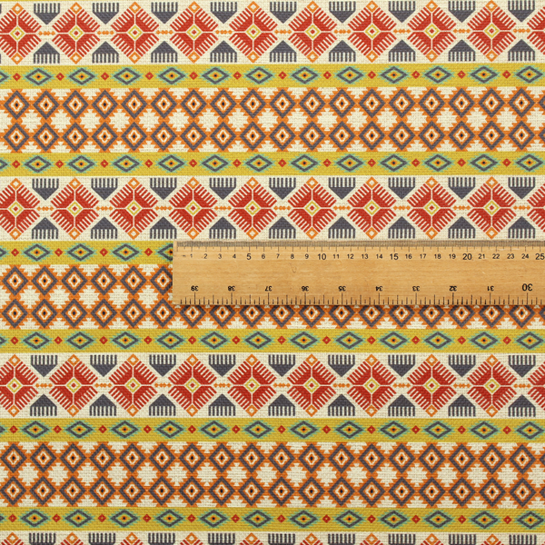 A vibrant, multi-coloured southwestern stripe pattern featuring repeating horizontal bands of geometric, tribal-inspired motifs. The detailed design is printed on a textured, linen-look cream fabric background, utilizing a bold colour palette of mustard yellow, terracotta red, slate blue-grey, and rust orange.