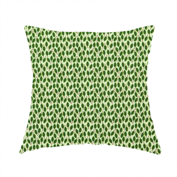 The fabric used to create this handmade cushion is a dense, small-scale pattern of miniature green leaves. The leaves are coloured dark green with subtle brown stems, arranged closely together in neat diagonal columns across a pale, light green background with a visible fine-woven texture.