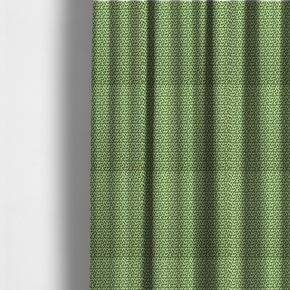 The fabric used to create these made-to-measure curtains is a dense, small-scale pattern of miniature green leaves. The leaves are coloured dark green with subtle brown stems, arranged closely together in neat diagonal columns across a pale, light green background with a visible fine-woven texture.