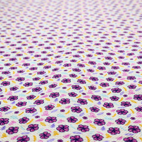 A dense, small-scale ditsy floral print. The pattern is composed of miniature five-petal magenta flowers outlined in dark purple, scattered symmetrically alongside tiny pastel pink blossoms, lavender leaves, and small ochre yellow botanical accents across a light, textured off-white background.