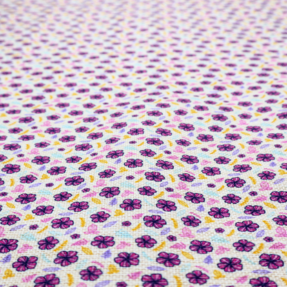 A dense, small-scale ditsy floral print. The pattern is composed of miniature five-petal magenta flowers outlined in dark purple, scattered symmetrically alongside tiny pastel pink blossoms, lavender leaves, and small ochre yellow botanical accents across a light, textured off-white background.