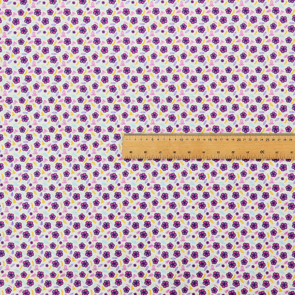 A dense, small-scale ditsy floral print. The pattern is composed of miniature five-petal magenta flowers outlined in dark purple, scattered symmetrically alongside tiny pastel pink blossoms, lavender leaves, and small ochre yellow botanical accents across a light, textured off-white background.