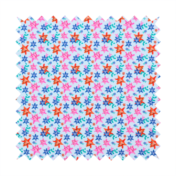 A dense, small-scale tropical ditsy pattern. The design consists of repeating star-shaped lily blossoms in bright shades of orange, magenta pink, and medium blue, accented with tiny teal green leafy sprigs and miniature blue flowers, all distributed across a solid light sky-blue background.