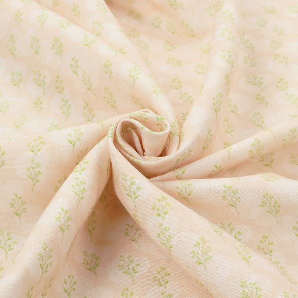 A soft watercolour design. The background consists of a subtle pastel peach wash layered with faint, painterly off-white circular polka dots. Arranged in neat diagonal rows over the circles are miniature, light lime green botanical sprigs and fine leaf stems.