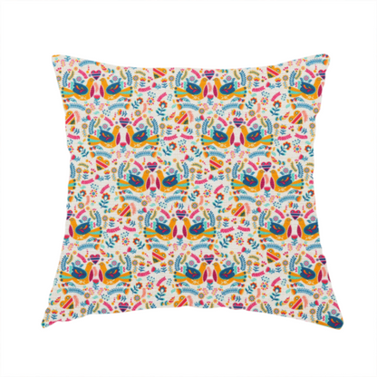 The fabric used to create this handmade cushion is a Scandinavian folk art pattern. The design features symmetrical pairs of stylized teal and golden-yellow lovebirds facing each other under a small striped heart. They are surrounded by an intricate all-over arrangement of tiny multi-coloured wildflowers, hearts, and vines in shades of orange, magenta, yellow, and blue over a textured, off-white background.
