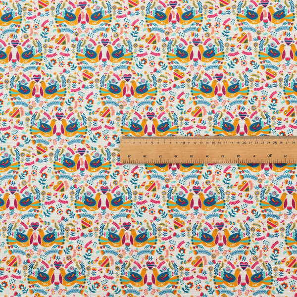 A Scandinavian folk art pattern. The design features symmetrical pairs of stylized teal and golden-yellow lovebirds facing each other under a small striped heart. They are surrounded by an intricate all-over arrangement of tiny multi-coloured wildflowers, hearts, and vines in shades of orange, magenta, yellow, and blue over a textured, off-white background.