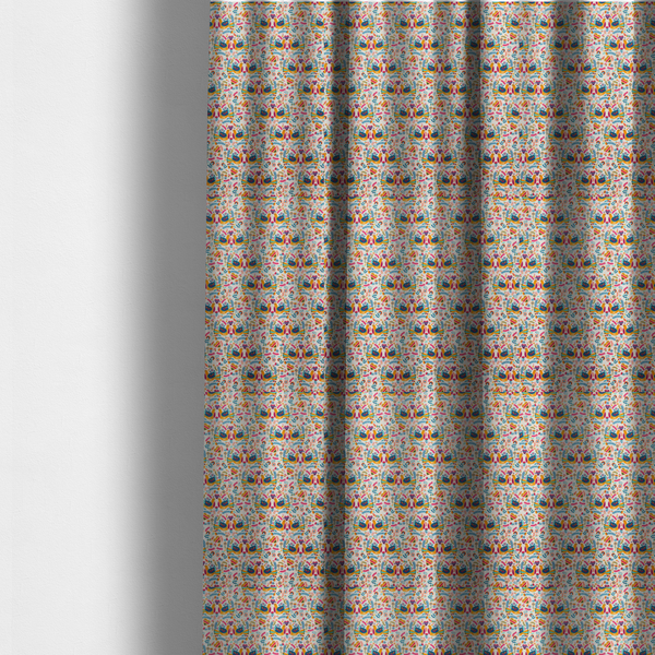 The fabric used to create these made-to-measure curtains is a Scandinavian folk art pattern. The design features symmetrical pairs of stylized teal and golden-yellow lovebirds facing each other under a small striped heart. They are surrounded by an intricate all-over arrangement of tiny multi-coloured wildflowers, hearts, and vines in shades of orange, magenta, yellow, and blue over a textured, off-white background.