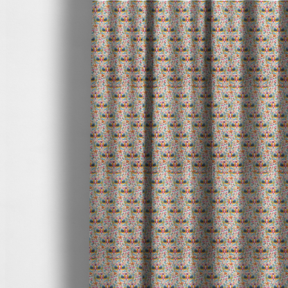 The fabric used to create these made-to-measure curtains is a Scandinavian folk art pattern. The design features symmetrical pairs of stylized teal and golden-yellow lovebirds facing each other under a small striped heart. They are surrounded by an intricate all-over arrangement of tiny multi-coloured wildflowers, hearts, and vines in shades of orange, magenta, yellow, and blue over a textured, off-white background.