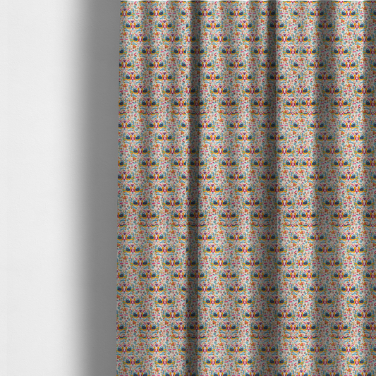The fabric used to create these made-to-measure curtains is a Scandinavian folk art pattern. The design features symmetrical pairs of stylized teal and golden-yellow lovebirds facing each other under a small striped heart. They are surrounded by an intricate all-over arrangement of tiny multi-coloured wildflowers, hearts, and vines in shades of orange, magenta, yellow, and blue over a textured, off-white background.