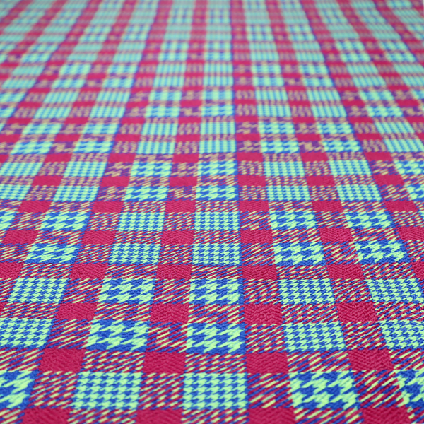 A dense, multi-coloured hounds tooth plaid pattern. The design features alternating blocks of bright magenta pink, electric royal blue, and neon lime green, interwoven into a structured, repetitive grid check with a classic textured twill appearance.