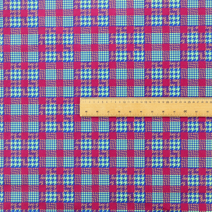 A dense, multi-coloured hounds tooth plaid pattern. The design features alternating blocks of bright magenta pink, electric royal blue, and neon lime green, interwoven into a structured, repetitive grid check with a classic textured twill appearance.
