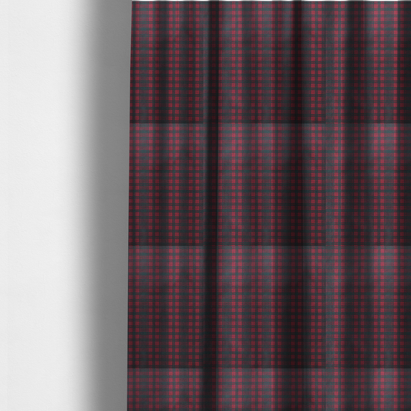 The fabric used to create these made-to-measure curtains is a classic, moody plaid pattern. The design is woven onto a dark charcoal grey background with a subtle, textured herringbone pattern, overlaid with a structured grid of thin, repeating intersecting lines in a bright, contrasting crimson red.
