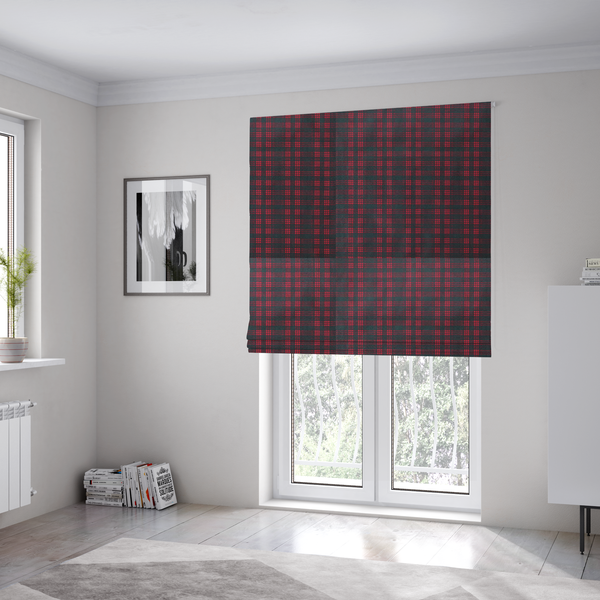 The fabric used to create these Roman blinds is a classic, moody plaid pattern. The design is woven onto a dark charcoal grey background with a subtle, textured herringbone pattern, overlaid with a structured grid of thin, repeating intersecting lines in a bright, contrasting crimson red.