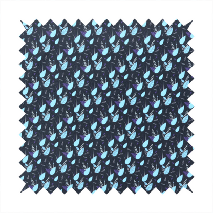 A dense, miniature botanical print. The design features small, light ice-blue teardrop shapes resembling abstract petals or water droplets, paired with tiny light blue textured leaves and white sprigs. The pattern is scattered over a dark charcoal grey background that features a subtle, woven herringbone texture.