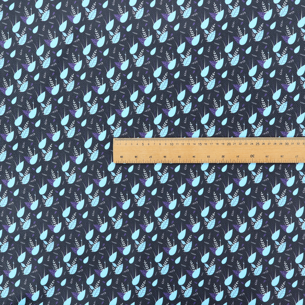 A dense, miniature botanical print. The design features small, light ice-blue teardrop shapes resembling abstract petals or water droplets, paired with tiny light blue textured leaves and white sprigs. The pattern is scattered over a dark charcoal grey background that features a subtle, woven herringbone texture.