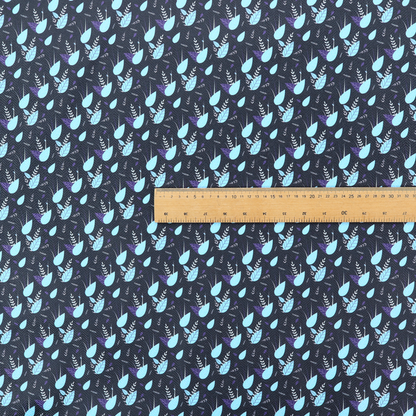 A dense, miniature botanical print. The design features small, light ice-blue teardrop shapes resembling abstract petals or water droplets, paired with tiny light blue textured leaves and white sprigs. The pattern is scattered over a dark charcoal grey background that features a subtle, woven herringbone texture.