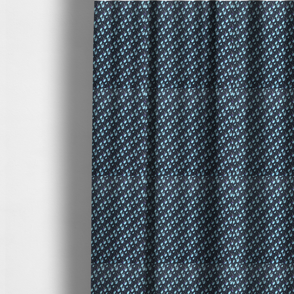 The fabric used to create these made-to-measure curtains is a dense, miniature botanical print. The design features small, light ice-blue teardrop shapes resembling abstract petals or water droplets, paired with tiny light blue textured leaves and white sprigs. The pattern is scattered over a dark charcoal grey background that features a subtle, woven herringbone texture.