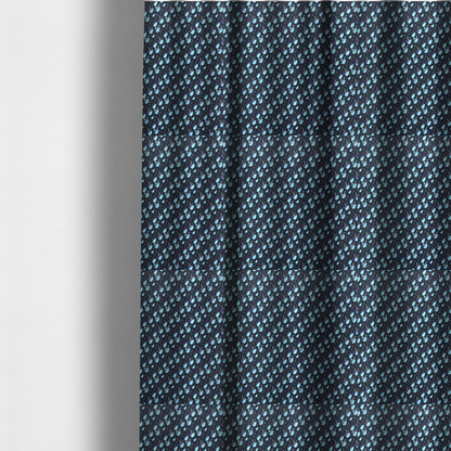 The fabric used to create these made-to-measure curtains is a dense, miniature botanical print. The design features small, light ice-blue teardrop shapes resembling abstract petals or water droplets, paired with tiny light blue textured leaves and white sprigs. The pattern is scattered over a dark charcoal grey background that features a subtle, woven herringbone texture.