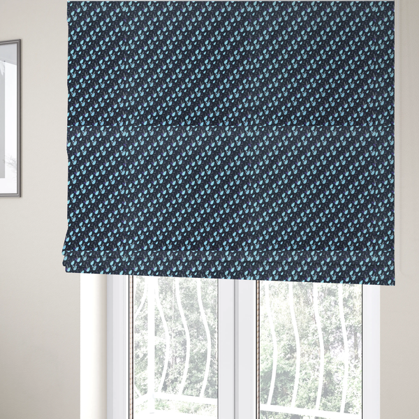 The fabric used to create these Roman blinds is a dense, miniature botanical print. The design features small, light ice-blue teardrop shapes resembling abstract petals or water droplets, paired with tiny light blue textured leaves and white sprigs. The pattern is scattered over a dark charcoal grey background that features a subtle, woven herringbone texture.