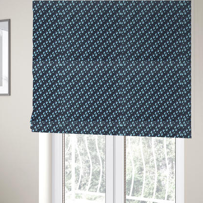 The fabric used to create these Roman blinds is a dense, miniature botanical print. The design features small, light ice-blue teardrop shapes resembling abstract petals or water droplets, paired with tiny light blue textured leaves and white sprigs. The pattern is scattered over a dark charcoal grey background that features a subtle, woven herringbone texture.