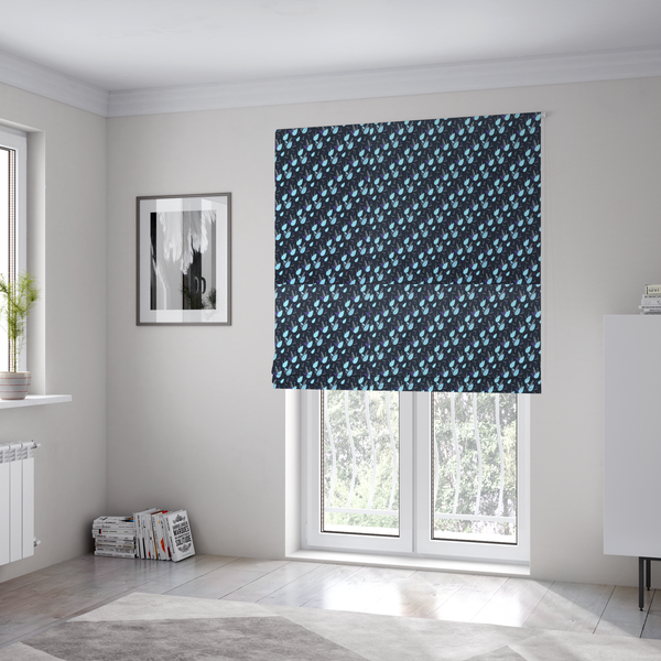 The fabric used to create these Roman blinds is a dense, miniature botanical print. The design features small, light ice-blue teardrop shapes resembling abstract petals or water droplets, paired with tiny light blue textured leaves and white sprigs. The pattern is scattered over a dark charcoal grey background that features a subtle, woven herringbone texture.