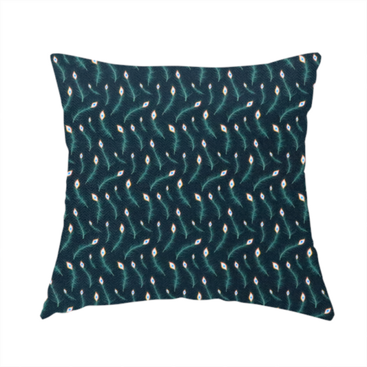 The fabric used to create these handmade cushions is a dense, elegant peacock feather motif. The design showcase a repetitive pattern of small, curved green peacock feathers with bright orange, blue, and white "eyes" floating diagonally. The pattern is set against a dark charcoal grey background that has a subtle, woven herringbone texture.
